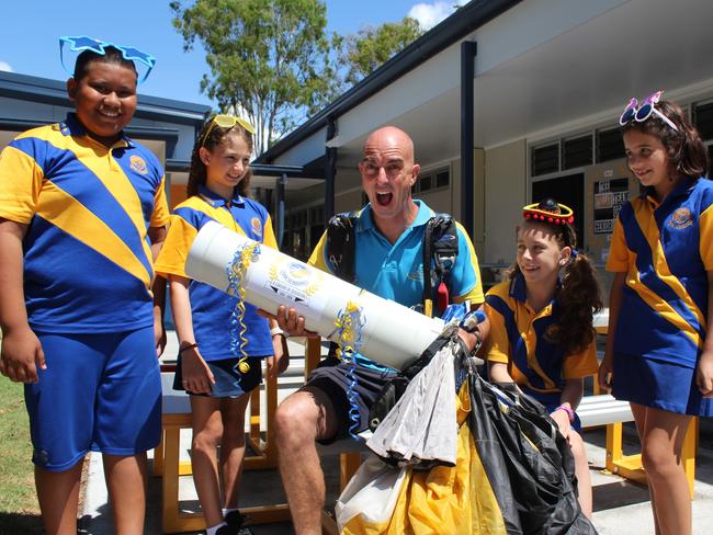 Coolangatta State School students Christian Faigane, Zoe Bird, Mia Joseph and Elissa Dudley talk to former student and Gold Coast Skydiving 'time capsule deliverer Archy Jamieson about the upcoming festivities this weekend. 