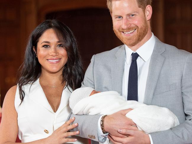 (FILES) In this file photo taken on May 08, 2019 Britain's Prince Harry, Duke of Sussex (R), and his wife Meghan, Duchess of Sussex, pose for a photo with their newborn baby son, Archie Harrison Mountbatten-Windsor, in St George's Hall at Windsor Castle. - Prince Harry and his wife Meghan's new home in Windsor cost £2.4 million ($3.05 million, 2.7 million euros) of taxpayers' money to renovate, royal accounts showed on June 25, 2019, prompting criticism from anti-monarchy campaigners. (Photo by Dominic Lipinski / POOL / AFP)