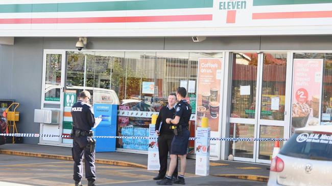 Police at the scene of an alleged stabbing incident at a Newtown 7/11 service station in Toowoomba.