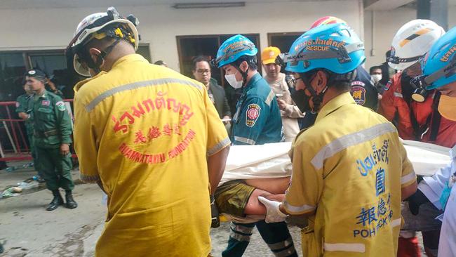 Rescue workers carry a victim on a stretcher after a fire at the Grand Diamond City hotel-casino. Picture: AFP.