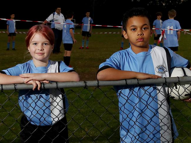 Grass roots sports clubs are in financial peril after the coronavirus has caused a drop in sponsorships and fundraising. Members of the Padstow Hornets U11 soccer team including Matilda Coughlin 9 (L) and Jaidyn Read 8 (R) with team mates pictured on Stuart St Reserve in Padstow. Picture: Toby Zerna