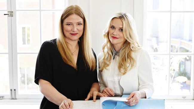 Bruna Papandrea, left, and Reese Witherspoon with a script of <i>Big Little Lies</i>, which HBO is<i/>developing for a series to be aired next year. Picture: The Wall Street Journal