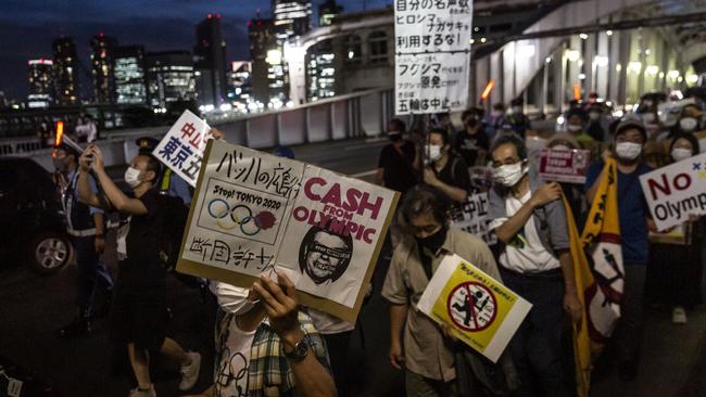 Protesters unhappy about the forthcoming Olympics march through the streets of Tokyo. Picture: Getty Images