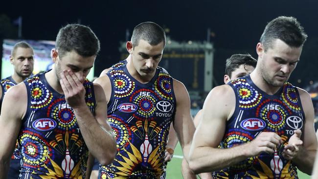 Taylor Walker, centre, trudges off Adelaide Oval with Rory Atkins and Brad Crouch walk off after the loss to the Eagles. Picture SARAH REED