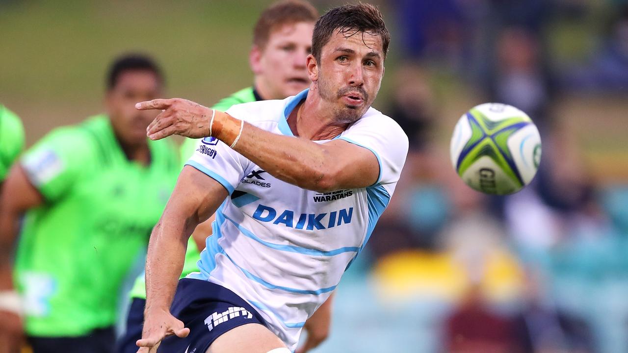 The Waratahs’ Jake Gordon gets a pass away against the Highlanders.