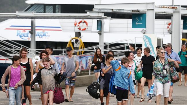 Tourists disembark from tourism operator boats that visit the Great Barrier Reef Marine Park on day trips from the Marlin Marina in Cairns. PICTURE: BRENDAN RADKE