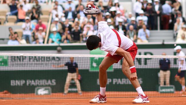 Novak Djokovic smashes his racquet into the Roland Garros clay.