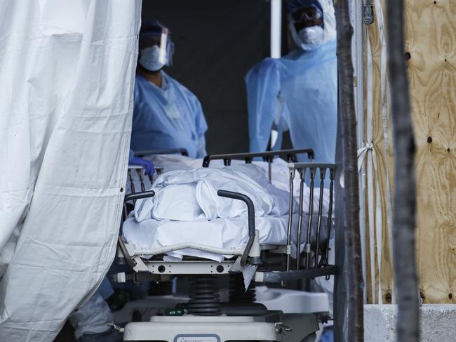 Bodies taken through a tent in New York at the height of the crisis. Picture: AP