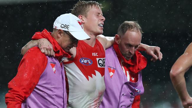 Isaac Heeney being helped from the ground after his injury. Picture: Getty Images