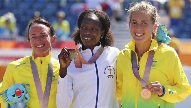 Namibia's gold medallist in women's marathon Helalia Johannes, centre, with Australia's silver and bronze medallists Lisa Weightman and Jess Trengove. Picture: AP / Manish Swarup