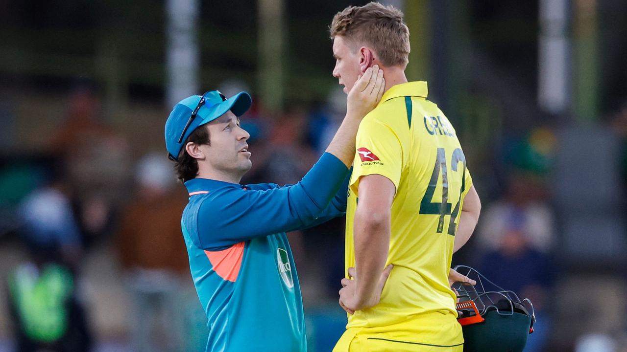 Cameron Green receives medical attention after being struck by a Kagiso Rabada bouncer. Picture: Phill Magakoe / AFP