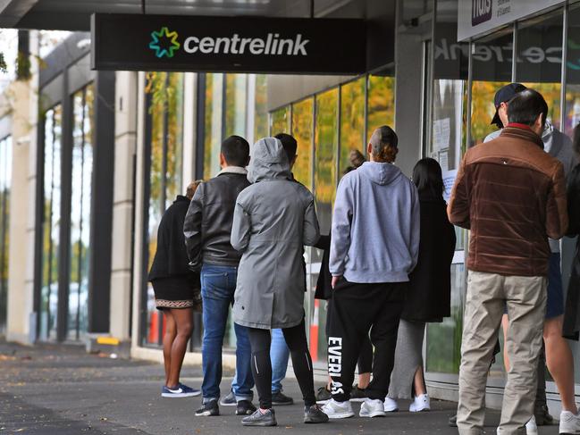 People queue up outside a Centrelink office. Picture: AFP