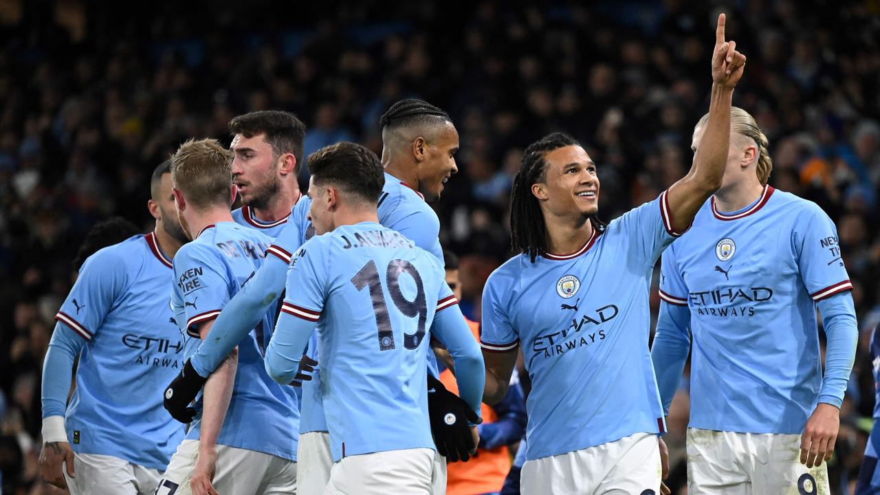 Manchester City's Dutch defender Nathan Ake (2ndR) celebrates with teammates after scoring their opening goal during the English FA Cup fourth round football match between Manchester City and Arsenal at the Etihad Stadium in Manchester, northwest England, on January 27, 2023. (Photo by Oli SCARFF / AFP)