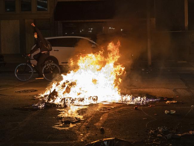 As night falls, protesters rally in downtown Indianapolis. Picture: AP