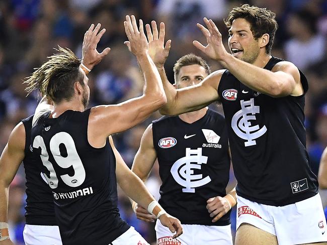 Levi Casboult (right) is congratulated by teammates after kicking a goal against the Bulldogs.