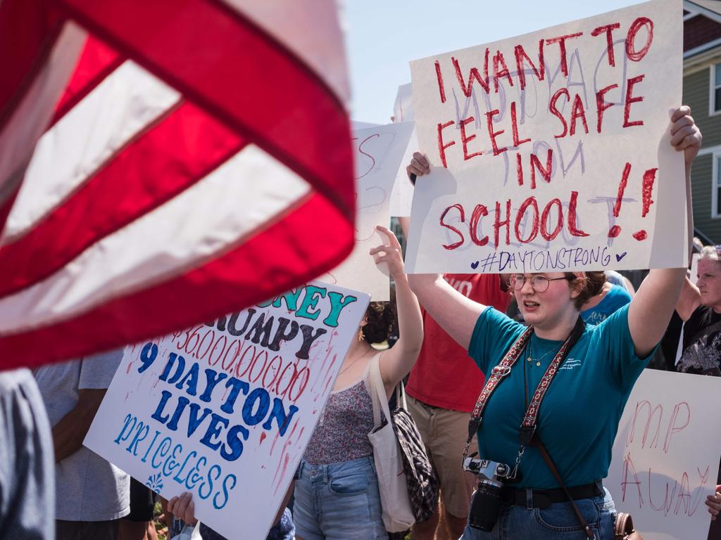 Outside the Ohio hospital, protesters held signs that called for restrictions on gun buying or, in one case, demanding impeachment proceedings. Picture: AFP