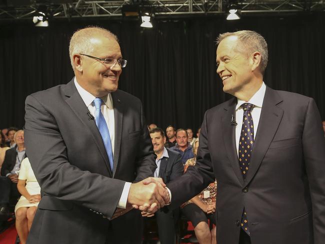 Australia's Prime Minister Scott Morrison (L) and opposition leader Bill Shorten shake hands before the first televised leaders debate in Perth on April 29, 2019. - The two men vying to lead Australia for the next three years faced off over the economy and plummeting trust in politicians in a testy first televised debate on April 19. (Photo by NIC ELLIS / POOL / AFP)