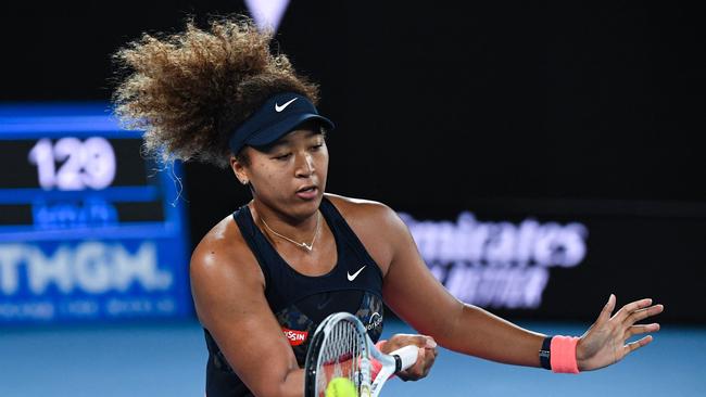 Japan's Naomi Osaka hits a return against Jennifer Brady of the US during their women's singles final match on day thirteen of the Australian Open tennis tournament in Melbourne on February 20, 2021. (Photo by William WEST / AFP) / — IMAGE RESTRICTED TO EDITORIAL USE – STRICTLY NO COMMERCIAL USE —