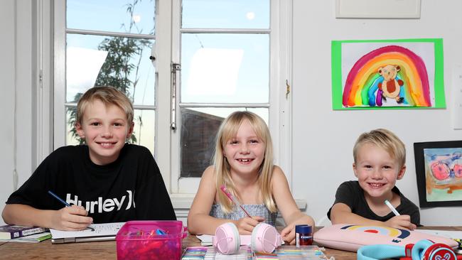 Gigi Molines, 7, with her brothers Axel, 4, and Oscar, 9, at home in Balgowlah doing homeschooling. Picture: Jonathan Ng