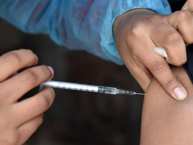 A boy is inoculated against the COVID-19 coronavirus disease at a mobile vaccination and testing medical unit in La Paz on July 19, 2022, as cases surge worldwide. - Fresh surges of Covid-19 infections around the world show the pandemic is nowhere near over, the World Health Organization's chief Tedros Adhanom Ghebreyesus lamented last week, warning that the virus is running free. The number of Covid-19 cases reported to the WHO increased 30 percent in the past two weeks, driven by sub-variants of the Omicron strain and the lifting of control measures. (Photo by Aizar RALDES / AFP)