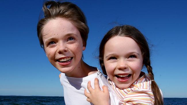 Piper 6 and Joshua 13 Seymour love growing up in Queensland and especially at the beach at Woody Point where they live. (Also with Poppy). Picture: Adam Head