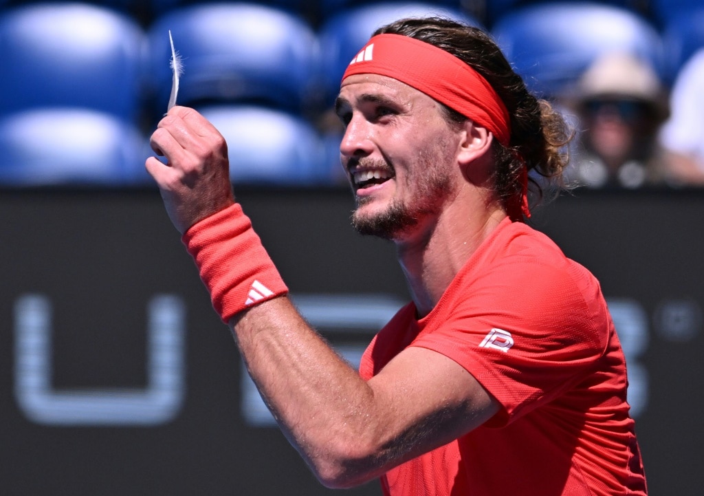 Germany's Alexander Zverev shows a feather to the umpire while arguing over a point