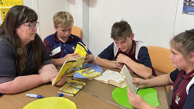 Moranbah East State School year six teacher Tracey Batchelor says she loves hearing about the success stories of her students after they left her care. Pictured with students Tye, Hayden and Kayhli. Picture: Contributed