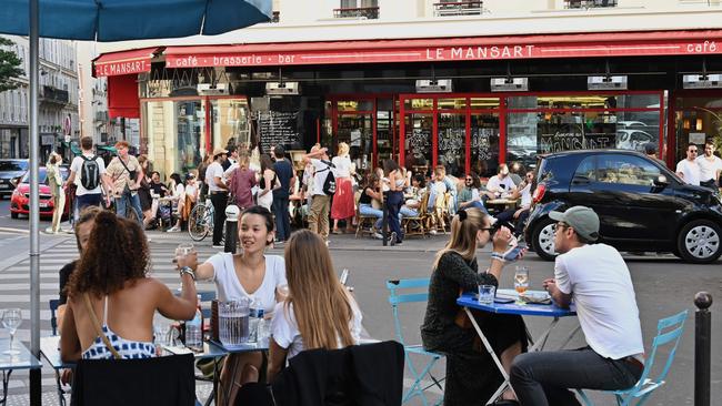 People eat and have drinks on restaurant and cafe terraces in Paris as cafes and restaurants reopen in France. Picture: AFP