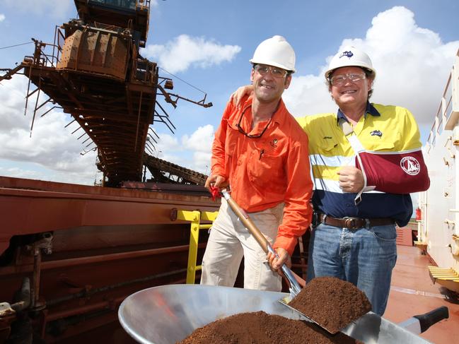 Fortescue Metals Group Chief Executive Andrew Forrest (yellow shirt) and BC Iron Managing Director Mike Young (orange shirt) during the first loading of iron ore from the Nullagine Iron Ore joint venture at Port Hedland, WA, and therefore the first historic loading of ore using third party access rail and port infrastructure, onto the iron ore ship MV Zosco Dalian.
