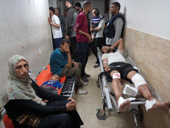An injured Palestinian man lies on a stretcher in a corridor at the Al-Aqsa Martyrs Hospital in the central Gaza Strip, following Israel bombardment. Picture: AFP