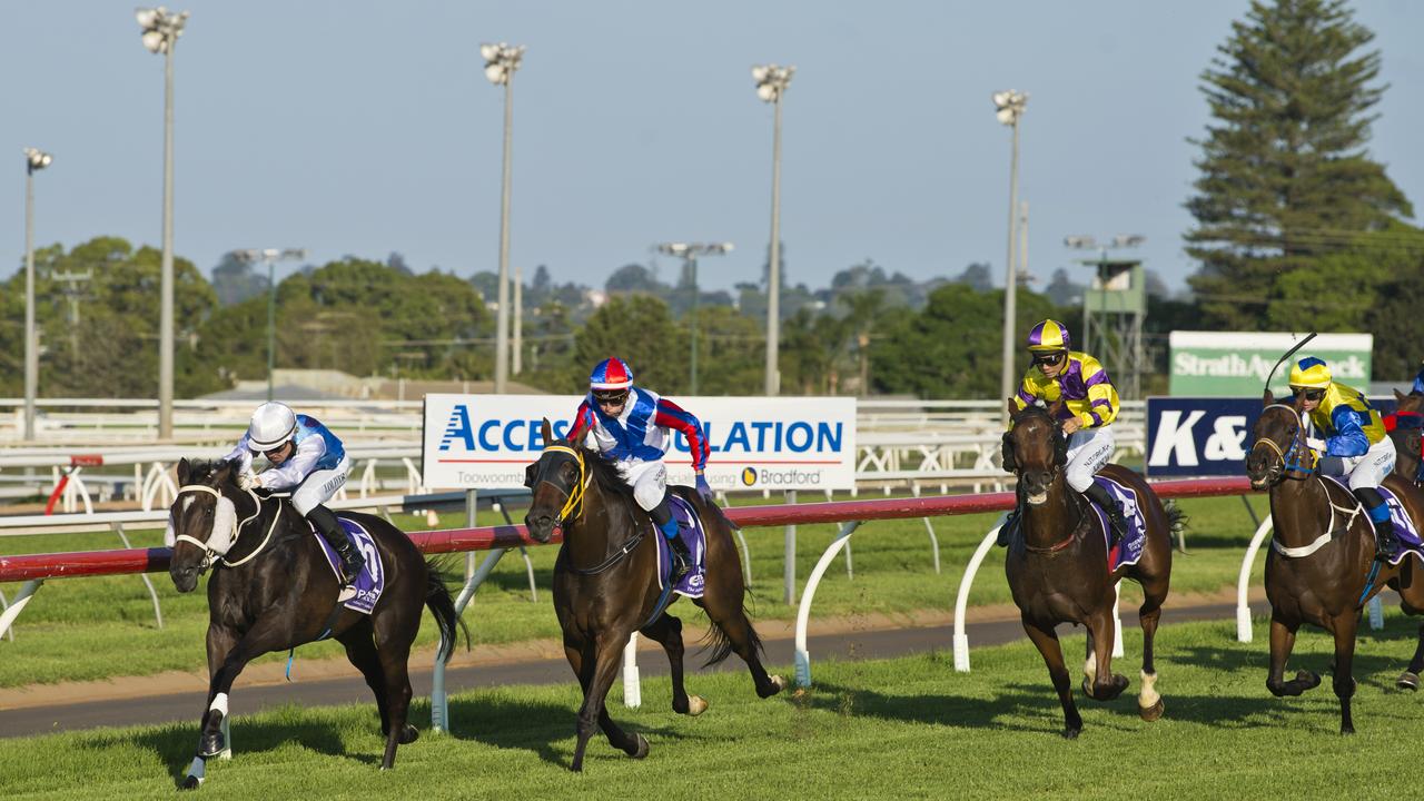 Josh Oliver and Love Yers All (left) race to victory in today’s Class 1 Handicap (1300m) at Clifford Park. Picture: Kevin Farmer