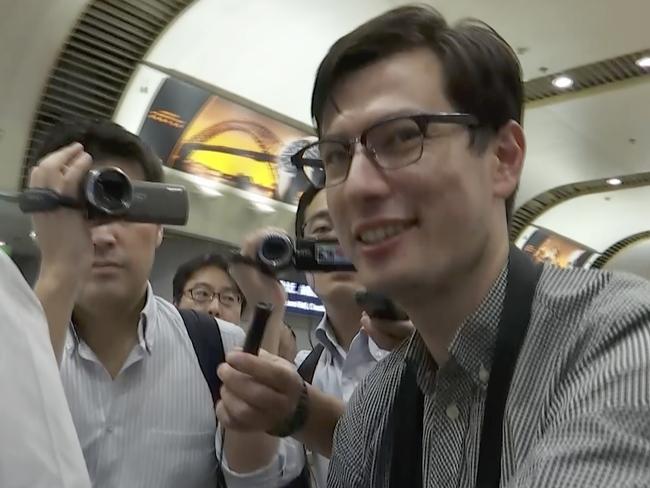 In this image made from video, Australian student Alex Sigley smiles as he arrives at the airport in Beijing. Picture: AP Photo/Emily Wang