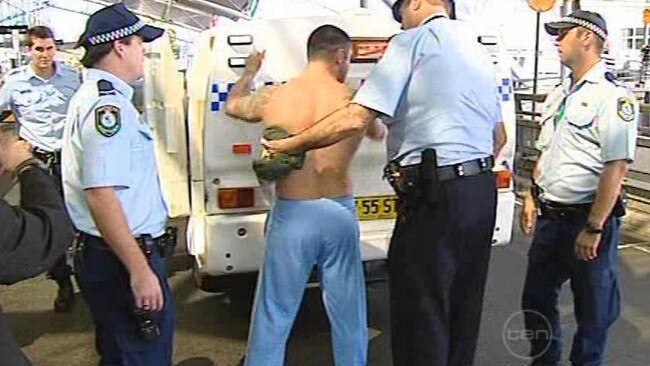 A man is arrested by police officers at Sydney's Mascot domestic airport after the bikie brawl in 2009. Picture: 10 News