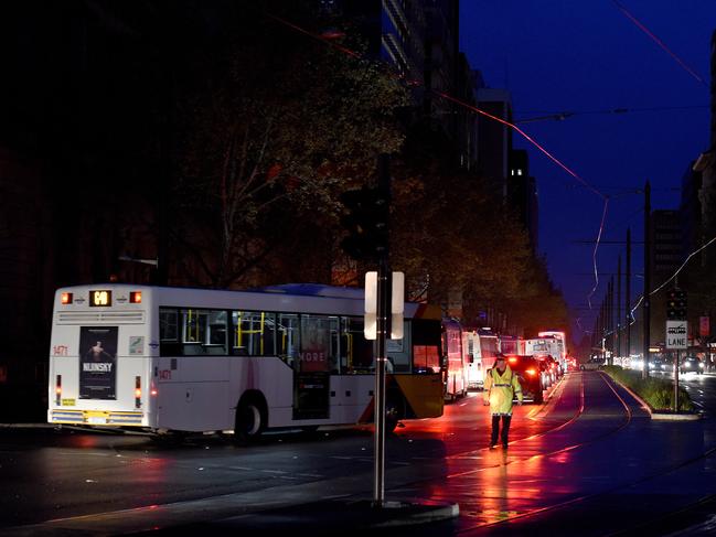 A police officer guiding traffic on King William Street in darkness. Photo: Naomi Jellicoe