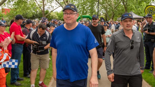 Police Chief Commissioner Graham Ashton (in blue) finishes the last few kms with Police Association Secretary Wayne Gatt (in grey) completing the combined 1,000km walk in Wangaratta in October to raise awareness and funds for retired police veterans living with mental health issues. Picture: Jason Edwards