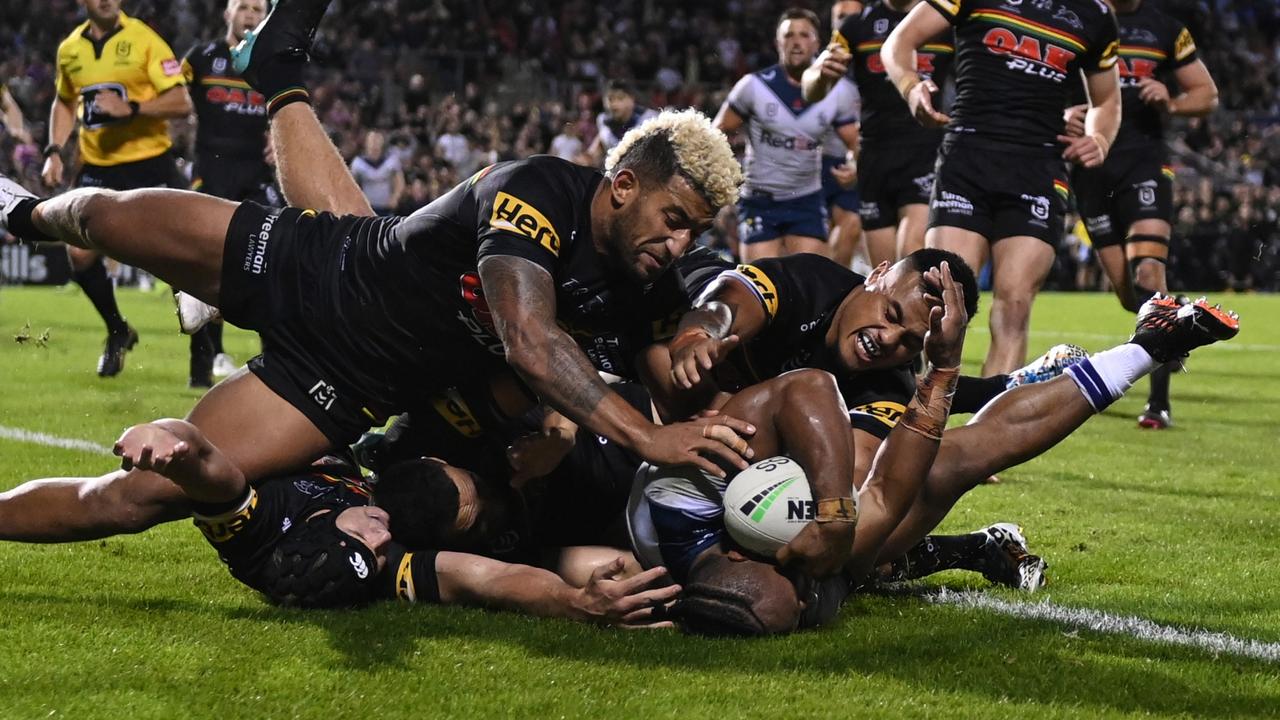 Viliame Kikau of the Panthers helps hold up Melbourne’s Justin Olam to win the game.