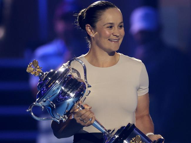 MELBOURNE, AUSTRALIA - JANUARY 14: Ash Barty walks the Daphne Akhurst Memorial Cup onto Rod Laver Arena during day one of the 2024 Australian Open at Melbourne Park on January 14, 2024 in Melbourne, Australia. (Photo by Julian Finney/Getty Images)