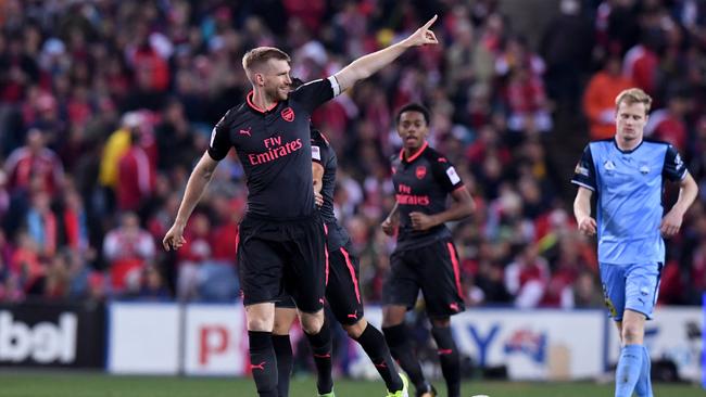 Per Mertesacker of Arsenal celebrates.