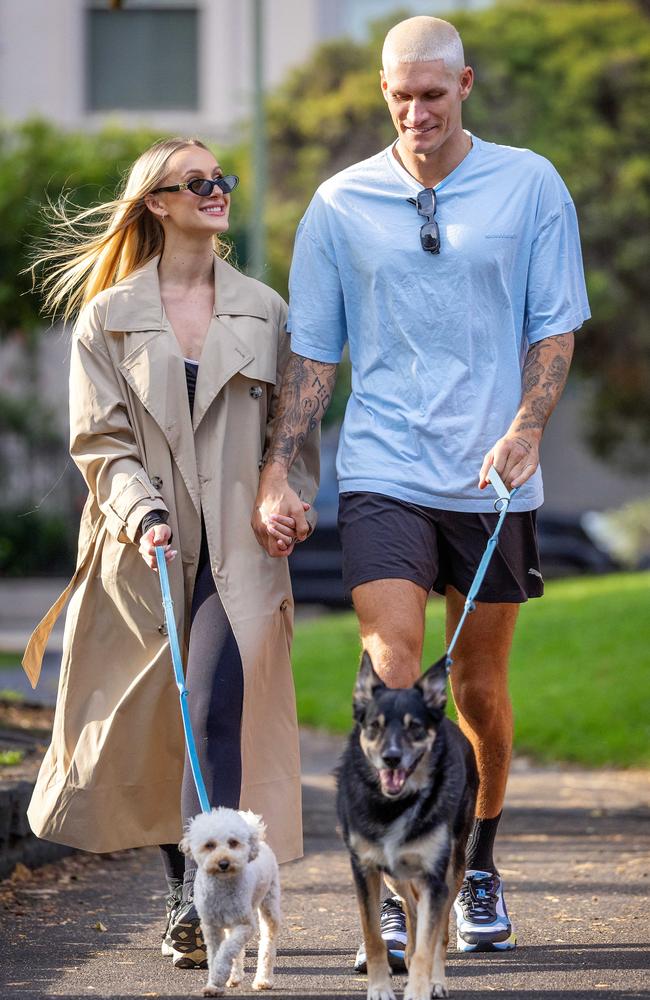 Influencer Lexi Mary and footballer Rory Lobb walk their dogs in Melbourne. Picture: Mark Stewart