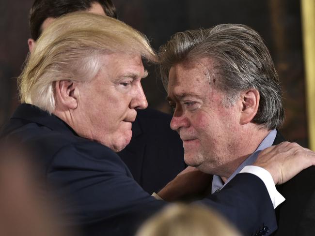 Mr Trump congratulates Senior Counselor to the President Stephen Bannon during the swearing-in of senior staff on January 22 this year. Picture: Mandel Ngan/AFP