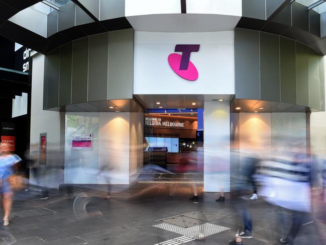 Pedestrians walk past a Telstra Corp. Discovery store in Melbourne, Australia, on Tuesday, Feb. 9, 2016. Telstra, Australia's biggest phone company, is scheduled to report half-year results on Feb. 18. Photographer: Carla Gottgens/Bloomberg