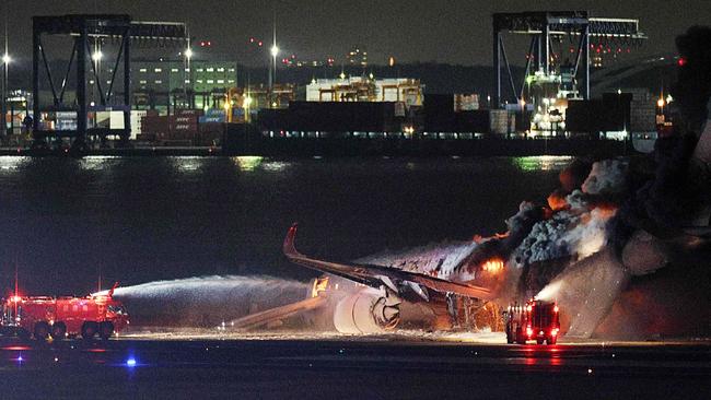 There was also burning debris on the runway. Picture: JIJI PRESS / AFP