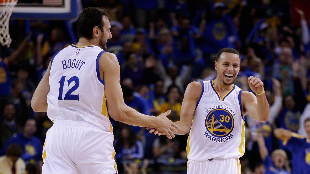 OAKLAND, CA - NOVEMBER 01: Stephen Curry #30 of the Golden State Warriors reacts with Andrew Bogut #12 after he threw a long down court assist to Klay Thompson #11 who made a three-point basket against the Los Angeles Lakers at ORACLE Arena on November 1, 2014 in Oakland, California. NOTE TO USER: User expressly acknowledges and agrees that, by downloading and or using this photograph, User is consenting to the terms and conditions of the Getty Images License Agreement. Ezra Shaw/Getty Images/AFP == FOR NEWSPAPERS, INTERNET, TELCOS & TELEVISION USE ONLY ==