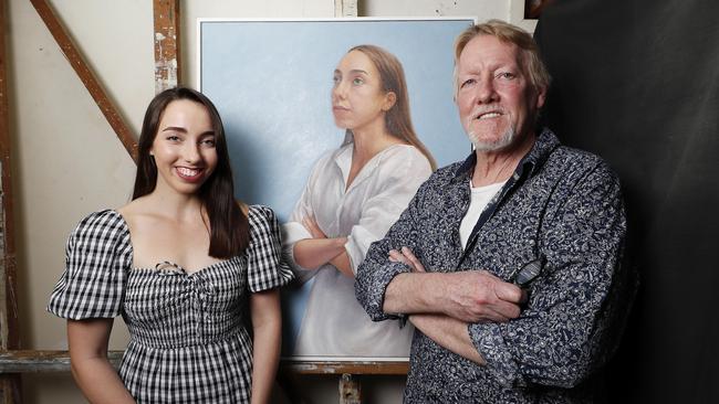 Artist Stephen Nothling and daughter Lily pictured at his home in Highgate Hill with the portrait he is entering in the Brisbane Portrait Prize. (Image/Josh Woning)