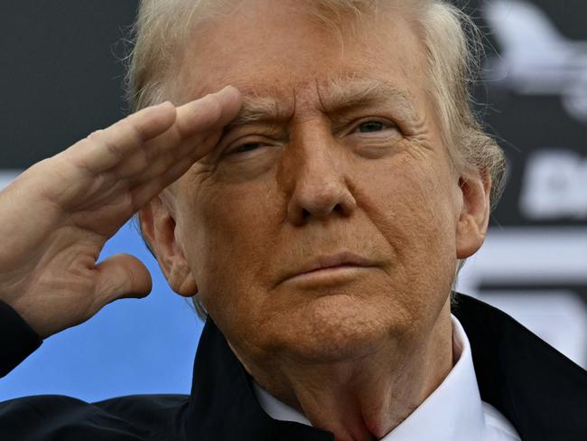 President Donald Trump salutes as he attends the NASCAR Daytona 500 auto race at Daytona International Speedway, Sunday, Feb. 16, 2025, in Daytona Beach, Fla. (Pool via AP)