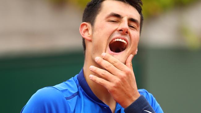 Bernard Tomic reacts during the Men's Singles first round match against Brian Baker.
