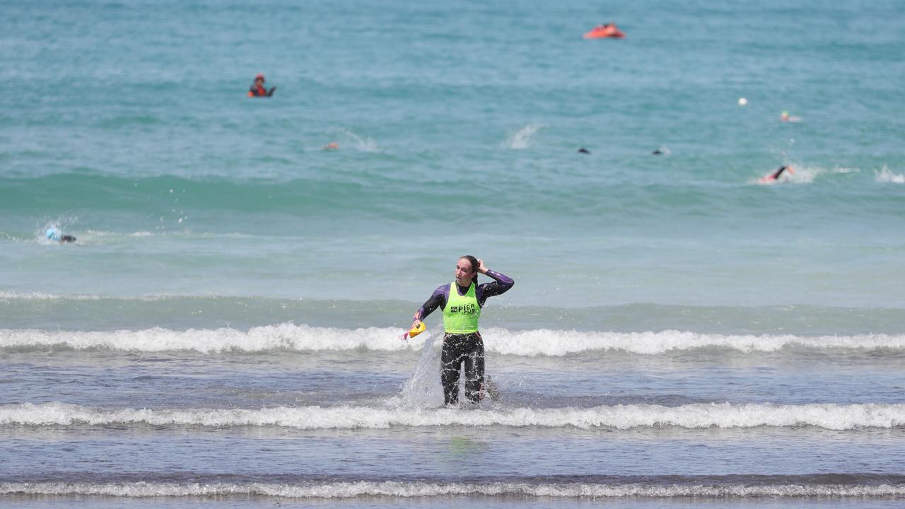 Lani Pallister emerges from the water first during Saturday’s Pier to Pub women’s Superfish race. Picture: Mark Wilson