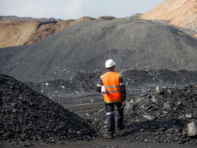 Coal mining in an open pit - Worker is looking on the huge open pit