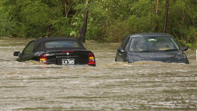 Two cars trapped by floodwaters on Wakehurst Parkway. Picture John Grainger