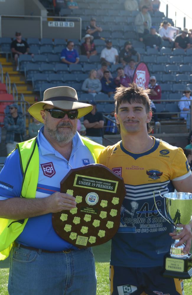 TRL president Joe Hannant hands the premiership to Highfields Eagles U19 captain Declan Ryan.